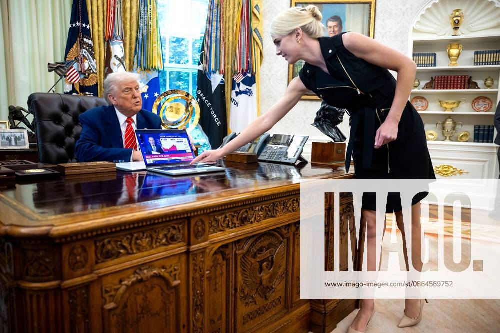 NATALIE HARP, a White House aide, is becoming a household name stemming from a comment by Sen. Jon Ossoff, D-Ga., who claimed Trump would rather build a ballroom and travel with Natalie than do his job as president. FILE PHOTO SHOT ON: May 30, 2025, Washington, DC, USA: US President DONALD TRUMP looks on as Natalie Harp, an aide, places a computer displaying a news report about the stock market, during a press conference with Elon Musk, Chief Executive Officer, Tesla, SpaceX and X and Administrator, Department of Government Efficiency (DOGE), in the Oval Office of the White House in Washington, DC. Washington USA - ZUMAs152 20250530_new_s152_033