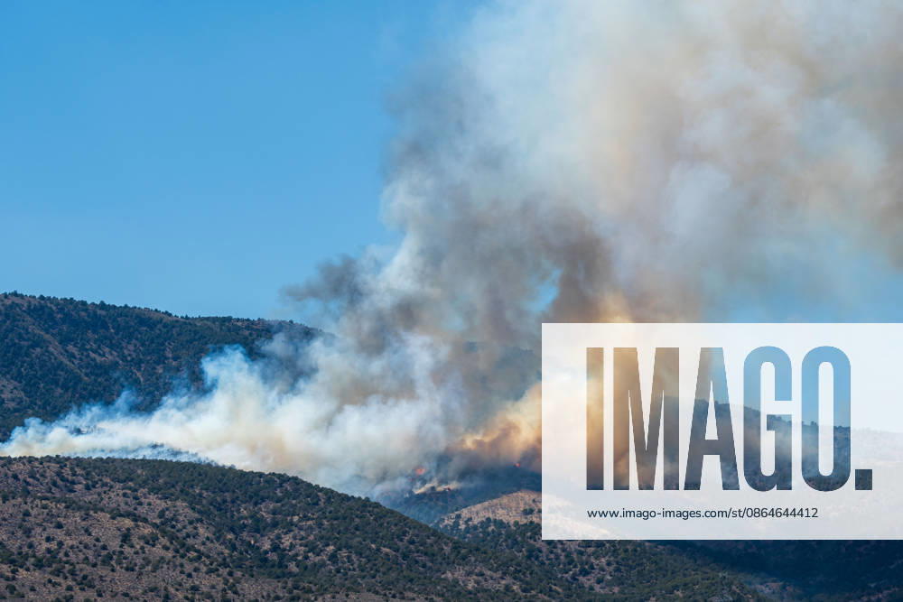 Smoke and flames are visible on a hillside as the Big Mountain Fire burns southwest of Elberta, Utah, United States, on August 23, 2026. State and local air and ground resources were deployed to fight the wildland fire, which rapidly reached an estimated 30 acres with zero containment. Elberta USA - ZUMAm292 20260823_znp_m292_017