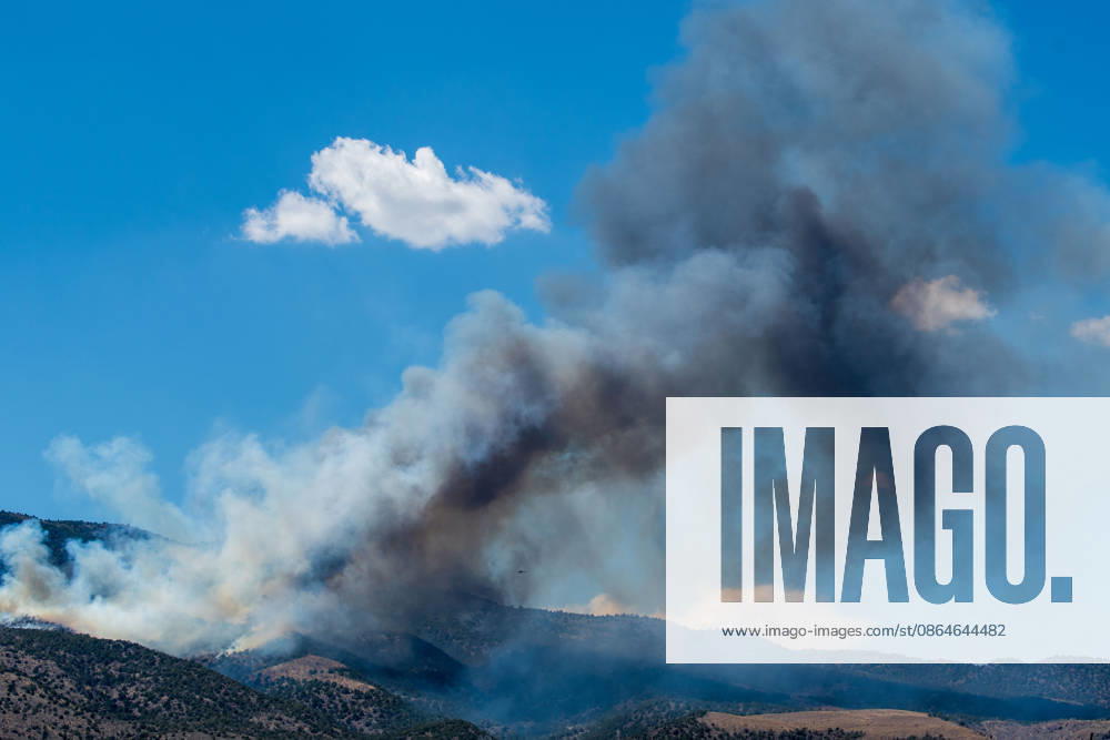 Smoke and flames are visible on a hillside as the Big Mountain Fire burns southwest of Elberta, Utah, United States, on August 23, 2026. State and local air and ground resources were deployed to fight the wildland fire, which rapidly reached an estimated 30 acres with zero containment. Elberta USA - ZUMAm292 20260823_znp_m292_022