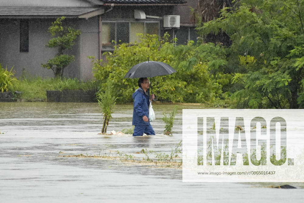 Torrential rain in central Japan A man walks on a flooded street in Himi in Toyama Prefecture, central Japan, on Aug. 27, 2026, following torrential rain. A14AA0005626692P