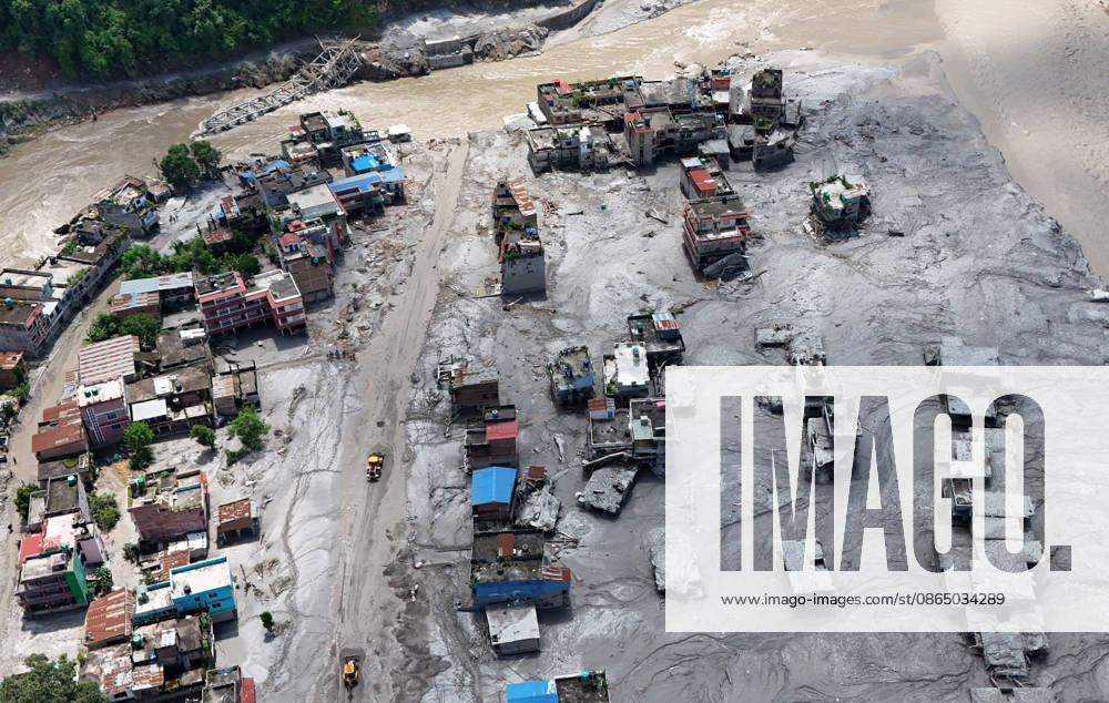 Bulldozers try to rebuild the roads after buildings and roads are buried in mud and debris following flash floods at Devighat in Bidur Municipality, Nuwakot district, Nepal, on Thursday, August 27, 2026. The floods, triggered by a glacial collapse and debris flow upstream, have killed at least 270 people and left 826 others out of contact, according to Nepalese authorities, with search and rescue operations continuing. Nuwakot Nepal - ZUMAg200 20260827_zap_g200_002
