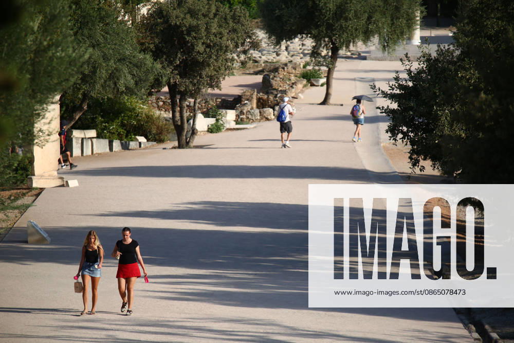 Tourists walk in the sun while visiting the Ancient Agora of Athens during hot summer weather. Athens Greece - ZUMAthen 20260827_mda_x103_784