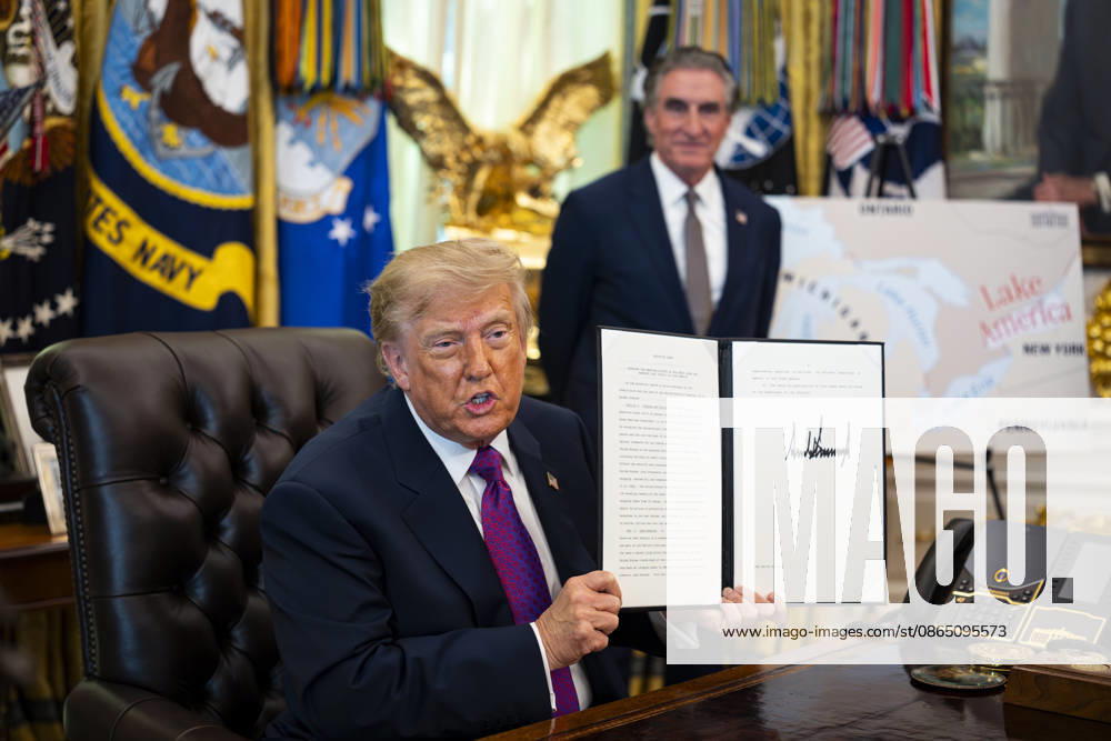 Amid a recent trade war with Canada, United States President DONALD J TRUMP shows a signed executive order to rename Lake Ontario as Lake America, in the Oval Office of the White House . Washington USA - ZUMAs152 20260827_faa_s152_005