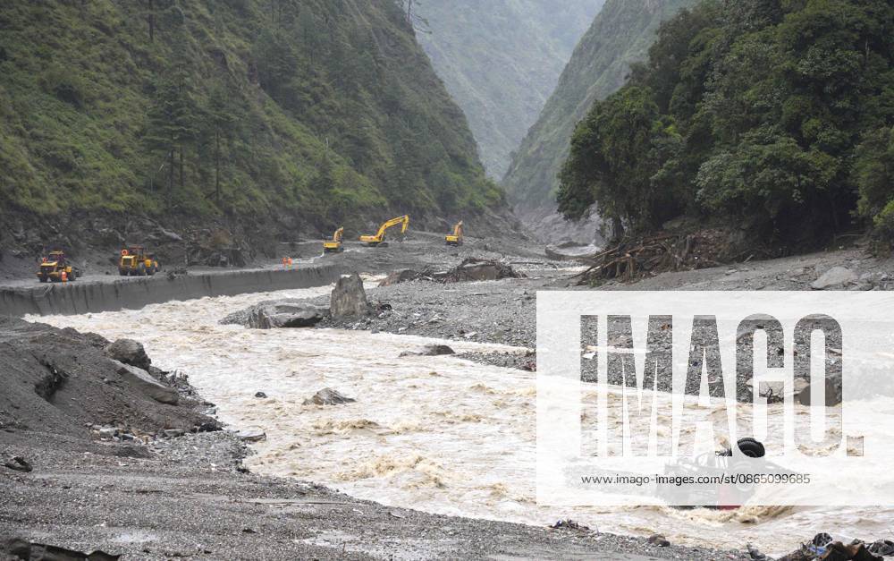Excavators and loaders clear debris on a damaged road section leading to the Gyirong Port on August 28, 2026 in Gyirong, Xizang Autonomous Region of China. Rescue efforts are underway after a mudslide struck near Gyirong Port in Gyirong County, Xigaze City, southwest China s Xizang Autonomous Region. Multiple rescue teams have been deployed to the affected area to search for missing people, clear roads and assess potential risks. Emergency supplies and rescue equipment have also been mobilized.