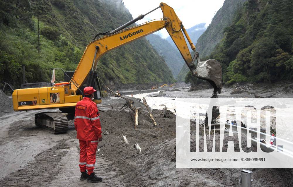 Excavators and loaders clear debris on a road leading to Gyirong Port on August 28, 2026 in Gyirong, Xizang Autonomous Region of China. Rescue efforts are underway after a mudslide struck near Gyirong Port in Gyirong County, Xigaze City, southwest China s Xizang Autonomous Region. Multiple rescue teams have been deployed to the affected area to search for missing people, clear roads and assess potential risks. Emergency supplies and rescue equipment have also been mobilized.