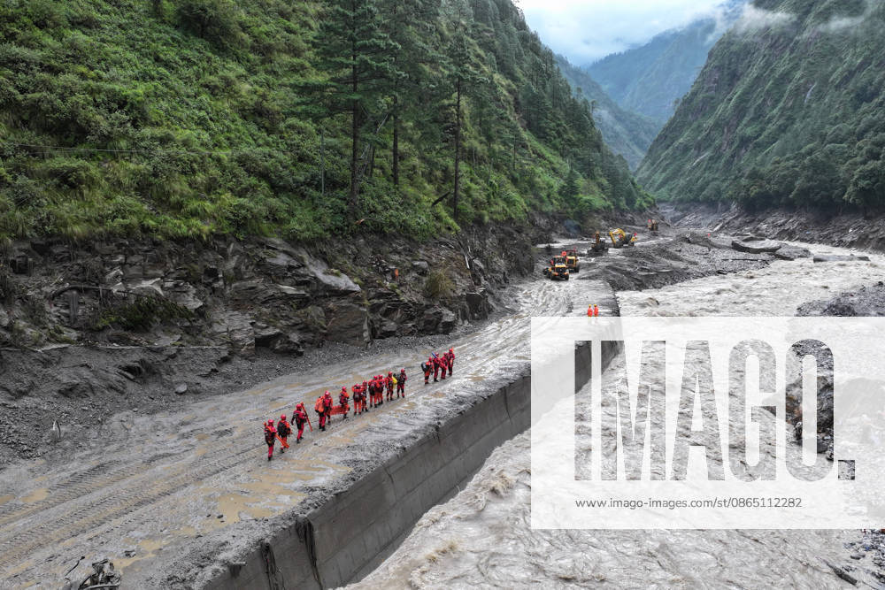 Rescue workers from the fire and rescue department conduct search operations at a disaster site on August 28, 2026 in Shigatse, Xizang Autonomous Region of China. A landslide occurred on the Nepal side of the border on August 26, causing casualties and missing persons near the Gyirong Port in Gyirong County; traffic authorities have cleared approximately 800 meters of the affected G216 highway section as of August 27.