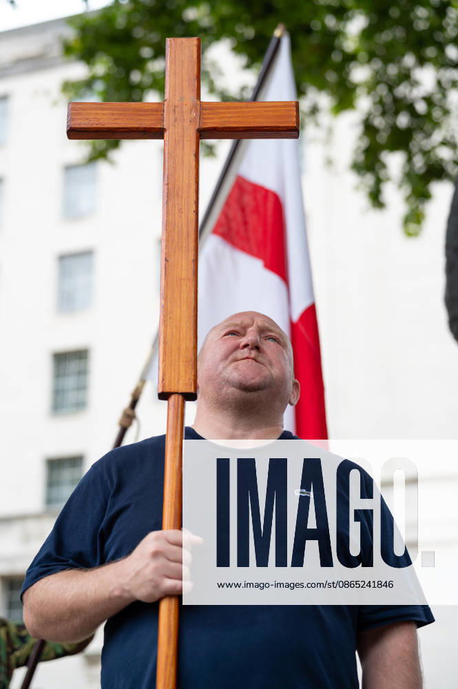 A UKIP supporter holds a wooden cross during speeches at the No Sharia Low march outside downing Street. Supporters of the UK Independence Party (UKIP), led by party leader Nick Tenconi, took part in the No Sharia Law march from Hyde Park Corner to Downing Street in London. Demonstrators marched through the capital opposing the application of Sharia law in the United Kingdom, carrying banners expressing opposition to Islamic immigration to the UK. London United Kingdom - ZUMAs197 20260829_aaa_s197_126