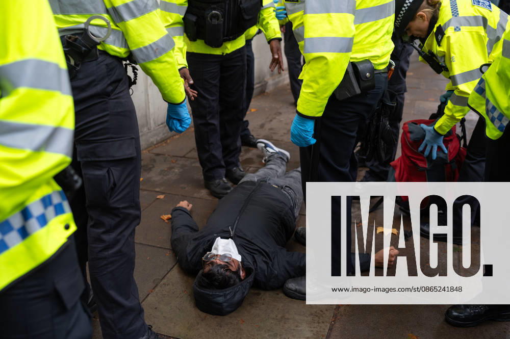A counter protester is being arrested by the police for not removing a face mask during the counter protest outside Downing Street opposing the No Sharia Low march. Supporters of the UK Independence Party (UKIP), led by party leader Nick Tenconi, took part in the No Sharia Law march from Hyde Park Corner to Downing Street in London. Demonstrators marched through the capital opposing the application of Sharia law in the United Kingdom, carrying banners expressing opposition to Islamic immigration to the UK. London United Kingdom - ZUMAs197 20260829_aaa_s197_128