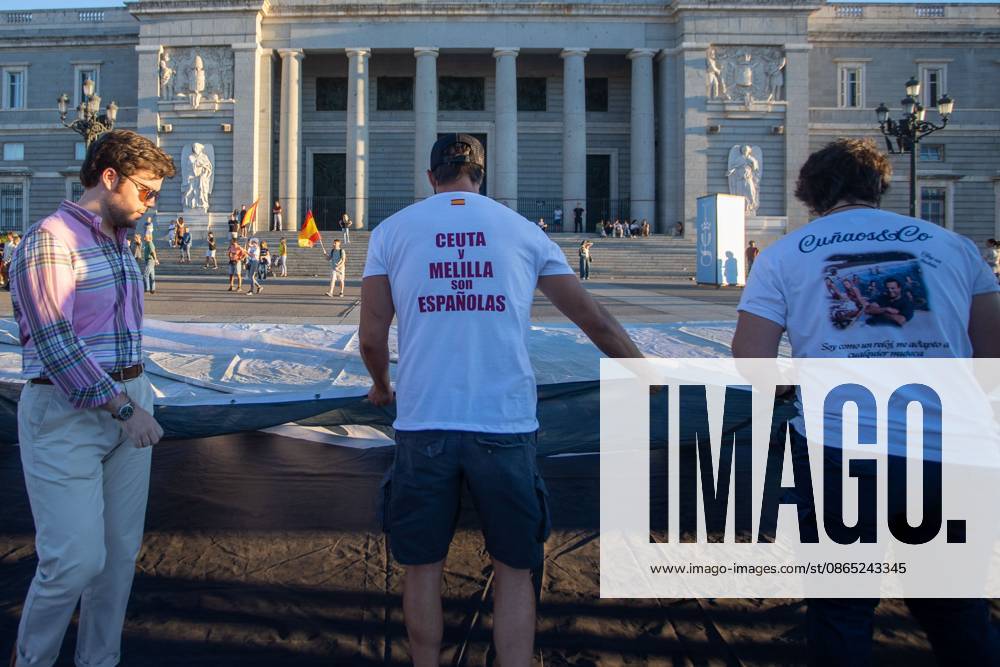 A man wears a white t-shirt that reads Ceuta and Melilla are Spanish during a rally in Madrid.Rally organized by far-right groups such as Europe Save Act, Revuelta, and Reconquista in support of remigration, under the slogan Save Spain, save Europe! Madrid Spain - ZUMAs197 20260829_aaa_s197_150