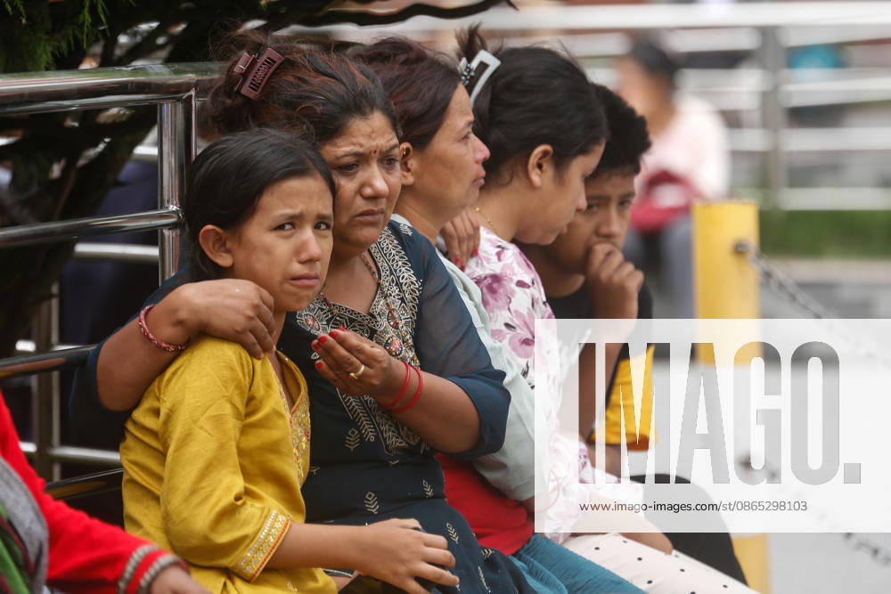 Nepal Floods - Aftermath Relatives of people missing after flash floods in Rasuwa and Nuwakot cry while searching for their loved ones at Tribhuvan University Teaching Hospital on August 30, 2026. Families examine photographs and missing-person notices as search and identification efforts continue. The floods destroyed homes and swept mud and debris downstream along the Trishuli River. Kathmandu Nepal