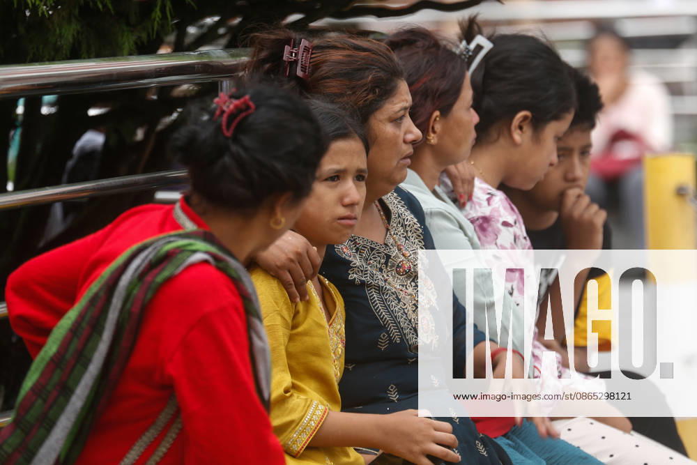 Nepal Floods - Aftermath Relatives of people missing after flash floods in Rasuwa and Nuwakot cry while searching for their loved ones at Tribhuvan University Teaching Hospital on August 30, 2026. Families examine photographs and missing-person notices as search and identification efforts continue. The floods destroyed homes and swept mud and debris downstream along the Trishuli River. Kathmandu Nepal