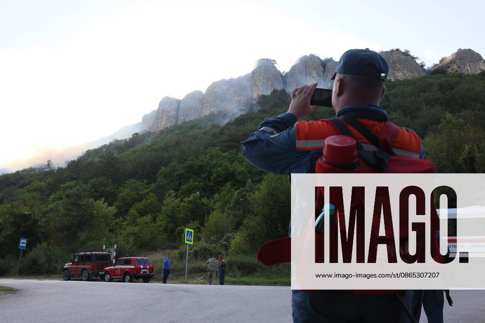 RUSSIA, REPUBLIC OF CRIMEA - AUGUST 30, 2026: Emergency service workers at the scene of a wildfire on Chishma-Kaya Rocks in the vicinity of Mangul-Kale in the Bakhchisarai District. Maxim Churusov TASS 96853711