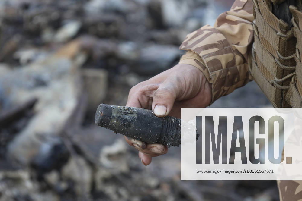 Binnish Syria Ammunition Explosion A uniformed man holds an object recovered from debris at the site of an explosion in Binnish, Idlib Governorate, Syria, on September 1, 2026. Five people were killed and several others injured when a vehicle loaded with ammunition exploded in Binnish, according to Syrian authorities, while the cause remained unclear and emergency crews worked to secure scattered munitions and prevent further explosions. Binnish Idlib Syria