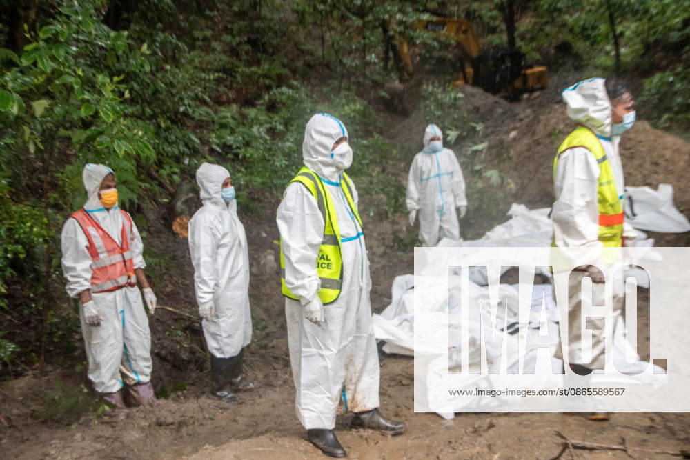 Bodies of unidentified victims wrapped in shrouds lie at a temporary burial trench in Gokarna, Kathmandu. Emergency teams collected DNA samples and forensic records prior to interment to assist family identification efforts later. Kathmandu Nepal - ZUMAs197 20260901_aaa_s197_254