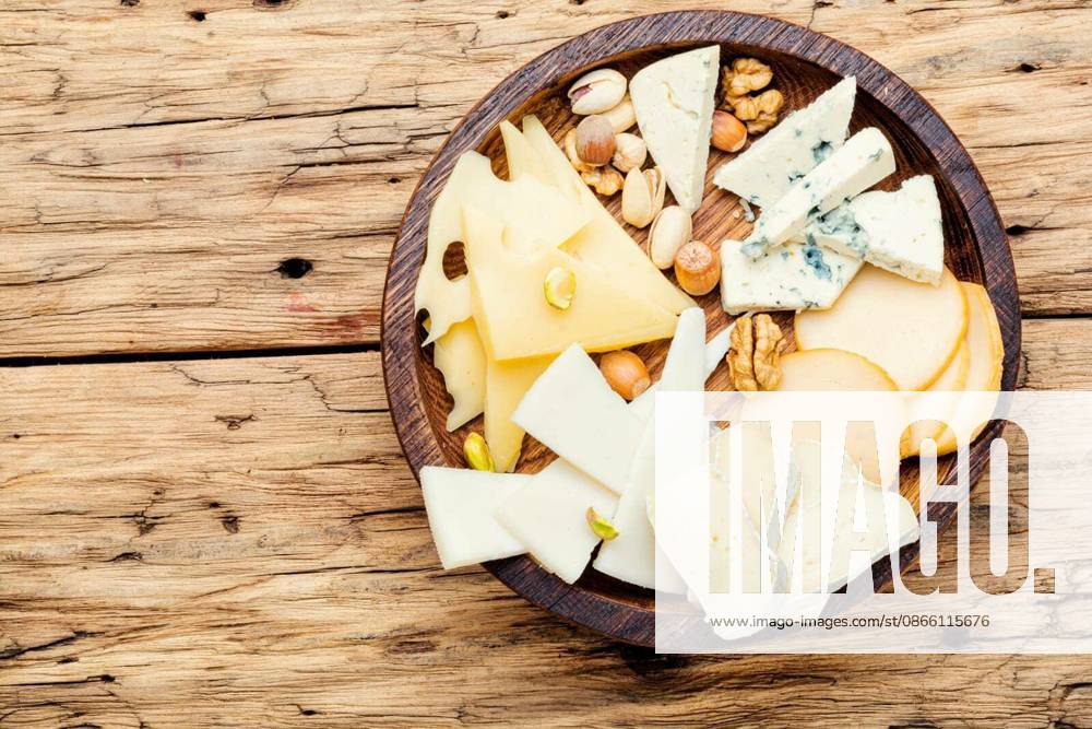 Cheese on the table.various types of cheese on old rustic wooden table