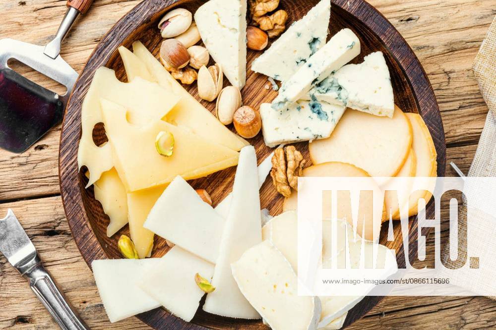 Cheese on the table.various types of cheese on old rustic wooden table