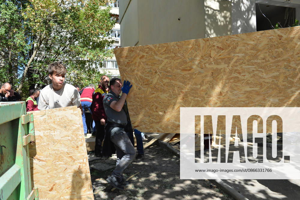 Men carry OSB boards to repair damage caused by a Russian attack in the Solomianskyi district, Kyiv, Ukraine, September 8, 2026. On Tuesday night, September 8, Russian forces launched another massive strike on the Ukrainian capital with ballistic and cruise missiles, as well as jet UAVs. The attack caused significant damage to civilian infrastructure, residential areas, and business facilities. Three people were killed, and 19 were injured. (Photo by Oleksandr Klymenko Ukrinform) Destruction and fires reported across Kyiv districts after Russian attack