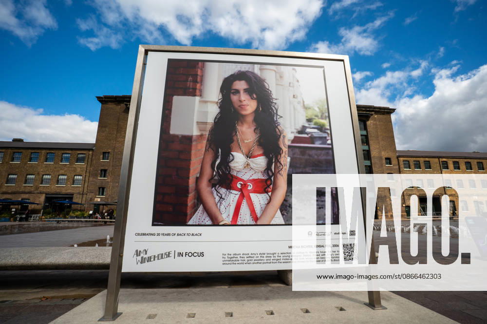 A portrait of Amy Winehouse by photographer Mischa Richter, taken in 2006, seen displayed as part of the ˜Amy Winehouse. Visitors view ˜Amy Winehouse: In Focus, a free outdoor photography exhibition at Granary Square and Kings Boulevard in Kings Cross, London. The exhibition features defining and previously unseen photographs of the late singer, offering an intimate portrait of her life and career and marking 20 years since the release of her acclaimed album ˜Back to Black. The exhibition runs from 1 September to 15 October 2026. London United Kingdom - ZUMAs197 20260909_aaa_s197_587