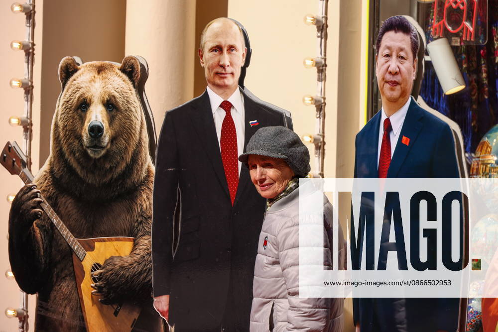 RUSSIA, MOSCOW - SEPTEMBER 10, 2026: A woman poses near cardboard cutouts of Russia s President Vladimir Putin and China s President Xi Jinping. Artyom Geodakyan TASS 97462721