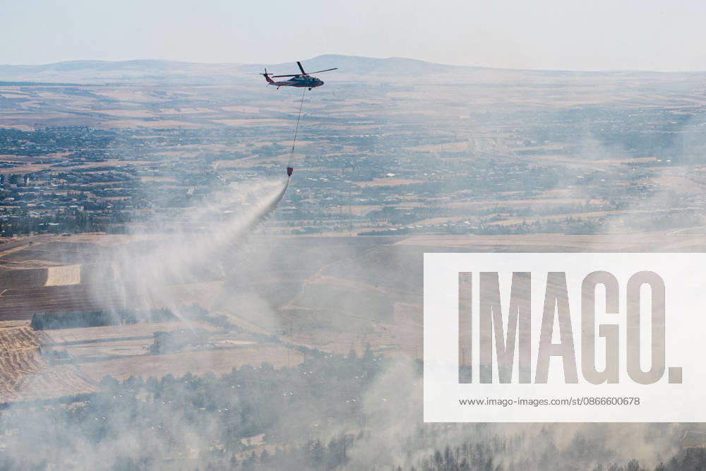 Forest fire in Turkish capital Ankara under control efforts ANKARA, TURKIYE - SEPTEMBER 11: A firefighting helicopter drops water over a forest fire near the Cicek Kent residential complex in the Taspinar neighborhood of Golbasi district in Ankara, Turkiye, on September 11, 2026. Firefighting teams were dispatched to the area to battle the blaze, which broke out for an unknown reason. Following reports of the fire, numerous fire engines, water tenders, tankers and police riot control vehicles were dispatched to the area, while a helicopter was also deployed to battle the blaze from the air. Harun Ozalp Anadolu Ankara Turkey. Editorial use only. Please get in touch for any other usage.