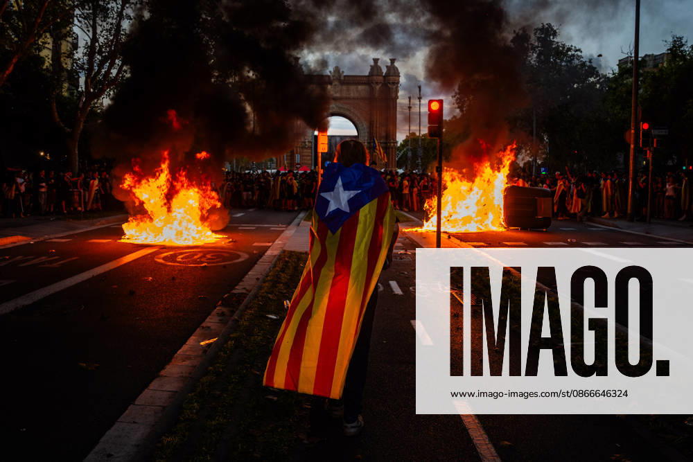 Anti-fascist protesters set fire to trash containers, erect barricades, and hurl projectiles at riot police during clashes in central Barcelona following the withdrawal of the far-right group Noºcleo Nacional from their planned demonstration site. The violent incidents erupted amidst tensions during the official commemorations of the Diada Nacional de Catalunya, prompting police charges and widespread damage to street furniture. Barcelona Spain - ZUMAa239 20260911_zip_a239_023