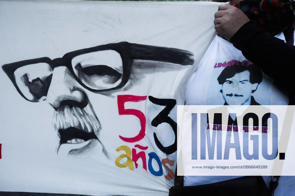 Demonstration march in commemoration of the 53rd anniversary of the coup d Ètat in ValparaÌso, Chile - 9 Sept 2026 A protester holds a canvas bearing Allende s face and wears a T-shirt depicting a victim of forced disappearance during a demonstration march commemorating the 53rd anniversary of the coup d Ètat in ValparaÌso. Valparaiso Chile