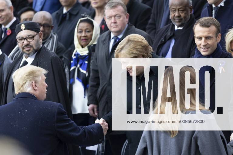 Paris, France - U.S. President Donald Trump, left, shakes hands with German Chancellor Angela Merkel, center as he arrives to join world leaders gathered for the Centennial of Armistice Day at the Arc de Triomphe November 11, 2018 in Paris, France. Armistice Day marks the end of World War I. Paris France - ZUMAp138 20181111_zaa_p138_009