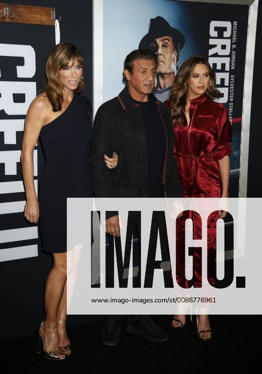 New York City, New York, U.S. - Actor SYLVESTER STALLONE with (L) JENNIFER FLAVIN and daughter (R) SCARLET ROSE STALLONE attend the World Premiere of Creed ll held at the AMC Lincoln Square Theater. New York City U.S. - ZUMAk03_ 20181114_zaf_k03_172