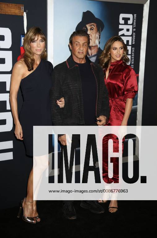 New York City, New York, U.S. - Actor SYLVESTER STALLONE with (L) JENNIFER FLAVIN and daughter (R) SCARLET ROSE STALLONE attend the World Premiere of Creed ll held at the AMC Lincoln Square Theater. New York City U.S. - ZUMAk03_ 20181114_zaf_k03_173