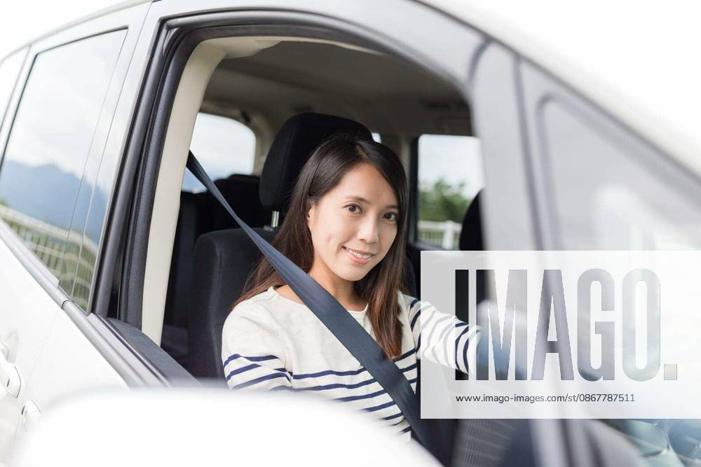Young Woman driving car model released Symbolfoto