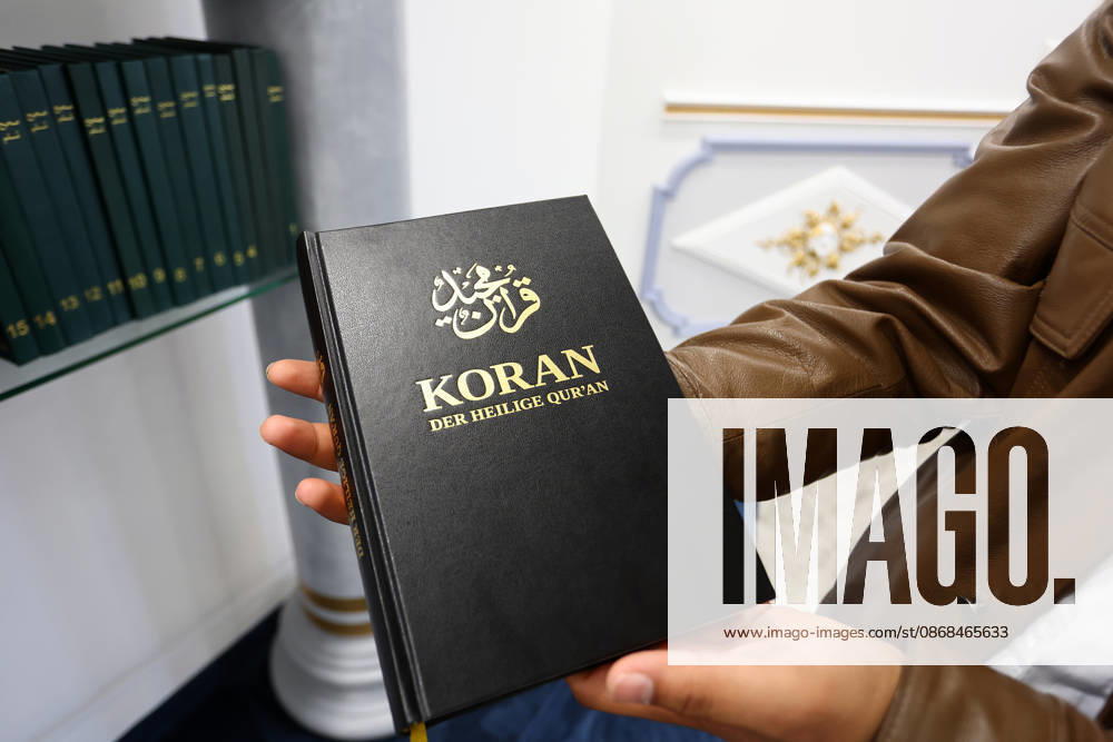 Open Mosque Day in Germany Open Mosque Day in Germany. A member shows the Quran book in the mosque Bait ur Rehman Moschee in Nuremberg, Germany . October 03rd , 2026 Photo by Davide Elias
