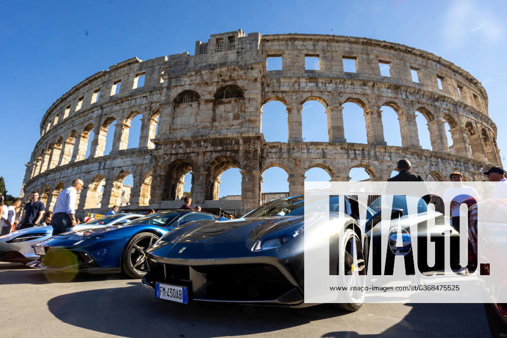Ferrari Tour stops in Pula Luxury Ferrari sports cars taking part in a Ferrari Tour organized by Ineco Auto, are seen in front of the Roman Arena in Pula, Croatia, on October 3, 2026. While the drivers visit the ancient amphitheatre, local residents gather to watch and admire the vehicles. SreckoxNiketic PIXSELL