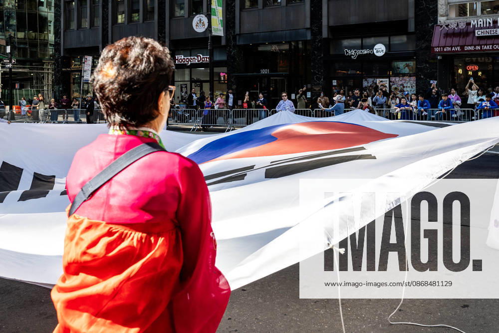 2026 NYC Korean Parade participants open a large Korean flag on Sixth Avenue. New York USA - ZUMAh214 20261003_znp_h214_001