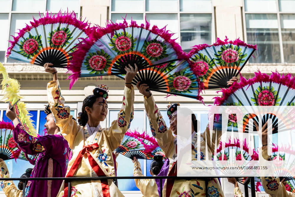Participants at the 2026 NYC Korean Parade raise their traditional fans while riding on a float during the parade. New York USA - ZUMAh214 20261003_znp_h214_011