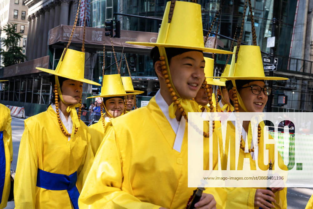 2026 NYC Korean Parade participants walk by in brightly colored yellow outfits. New York USA - ZUMAh214 20261003_znp_h214_016