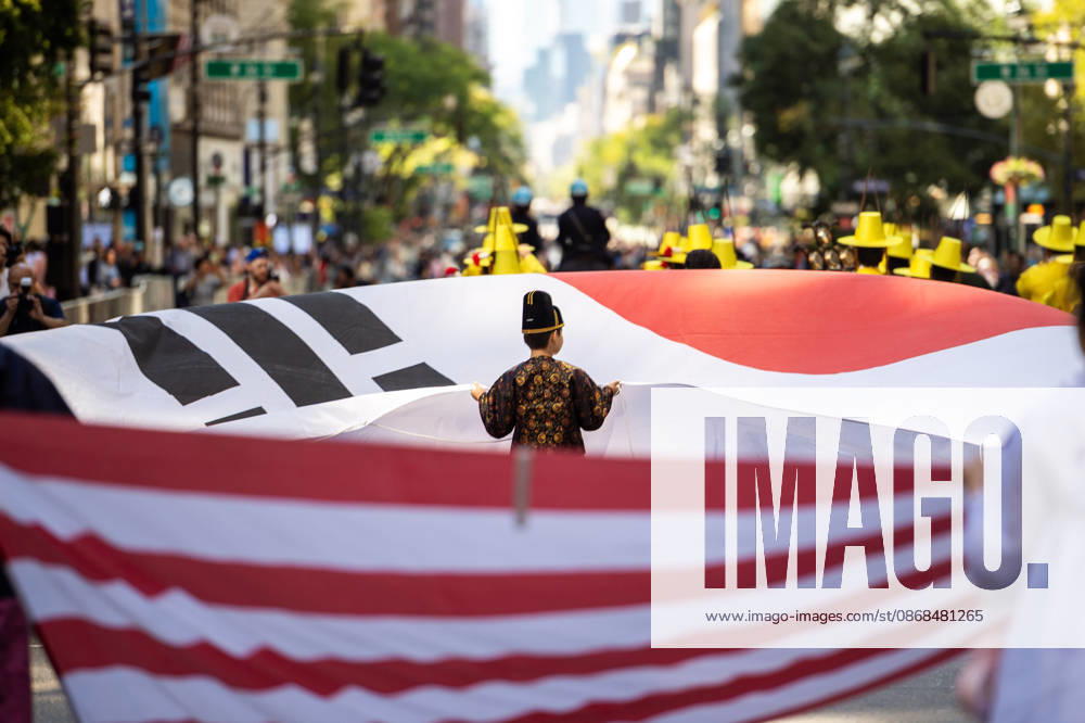 A small child holds up their end of the Korean flag at the 2026 NYC Korean parade. New York USA - ZUMAh214 20261003_znp_h214_030