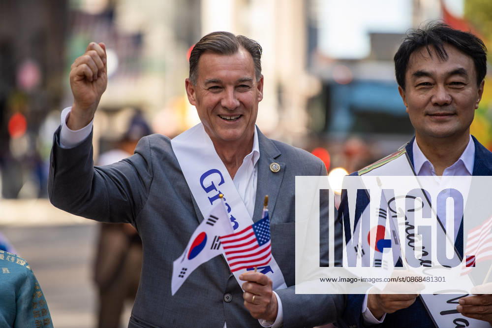 US congressman TOM SUOZZI poses for a photo with a fellow grand mashal while marching in the 2026 NYC Korean parade. New York USA - ZUMAh214 20261003_znp_h214_035