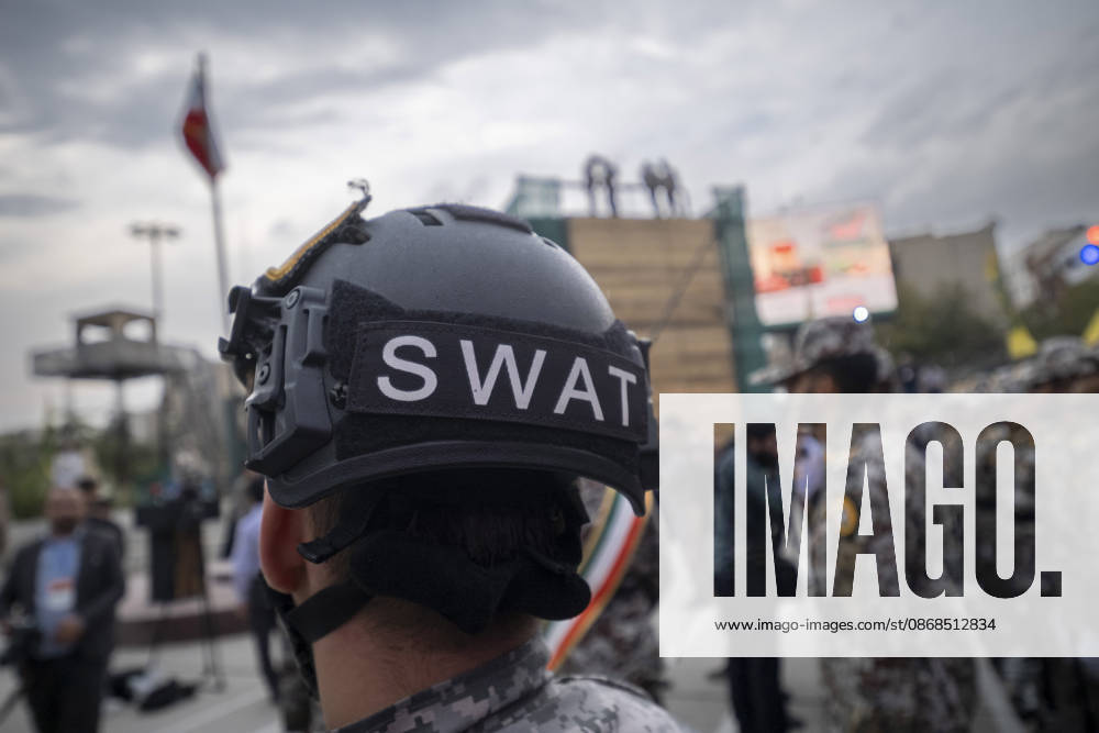 Opening Ceremony Of Second City-Square Military Training Camp A member of the Islamic Revolutionary Guard Corps (IRGC) attaches a SWAT badge to his helmet during the opening ceremony of the second city-square military training camp for self-sacrificing forces in downtown Tehran, Iran, on October 3, 2026. The camp was established by the Basij paramilitary force, with personnel from the Islamic Republic of Iran Army responsible for training the volunteers. Tehran Tehran Iran