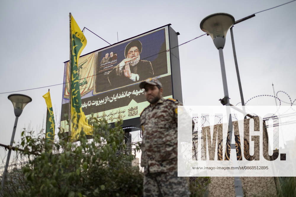 Opening Ceremony Of Second City-Square Military Training Camp An Iranian Army serviceman in uniform stands beneath a portrait of Hassan Nasrallah, the late secretary general of Lebanon s Hezbollah, during the opening ceremony of the second city-square military training camp for self-sacrificing forces in downtown Tehran, Iran, on October 3, 2026. The camp was established by the Basij paramilitary force, with personnel from the Islamic Republic of Iran Army responsible for training the volunteers. Tehran Tehran Iran