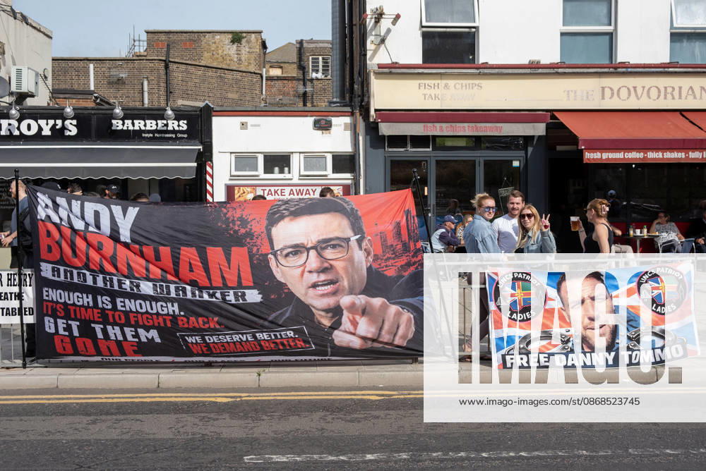 Two banners installed on the fence near the Golden Lion pub during a demonstration in Dover. The left banner shows a photo of the UK Prime Minister, Andy Burnham and the right one shows a far-right activist Danny Tommo (Daniel Thomas). Supporters of the English Defence League (EDL) gathered in Dover, UK to march through the town all the way to the harbour. English Defence League is an extreme far-right and Islamophobic organisation. It was founded by Tommy Robinson (pseudonym of Steven Yaxley-Lennon) in 2009. Dover United Kingdom - ZUMAs197 20261003_aaa_s197_245