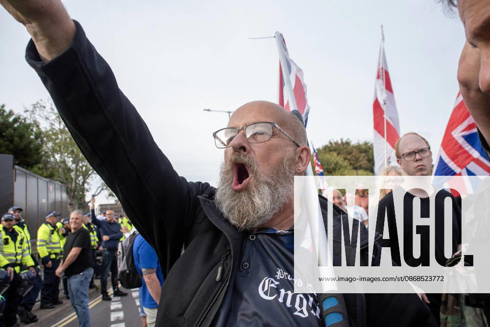 A far-right protester shouts abusive slogans on to the antifascist protesters during a demonstration in Dover. Supporters of the English Defence League (EDL) gathered in Dover, UK to march through the town all the way to the harbour. English Defence League is an extreme far-right and Islamophobic organisation. It was founded by Tommy Robinson (pseudonym of Steven Yaxley-Lennon) in 2009. Dover United Kingdom - ZUMAs197 20261003_aaa_s197_247