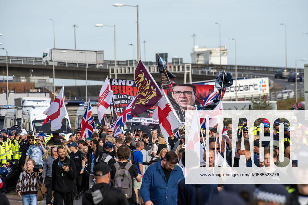 Far-right protesters march with banner and flags near the harbour during a demonstration in Dover. Supporters of the English Defence League (EDL) gathered in Dover, UK to march through the town all the way to the harbour. English Defence League is an extreme far-right and Islamophobic organisation. It was founded by Tommy Robinson (pseudonym of Steven Yaxley-Lennon) in 2009. Dover United Kingdom - ZUMAs197 20261003_aaa_s197_249