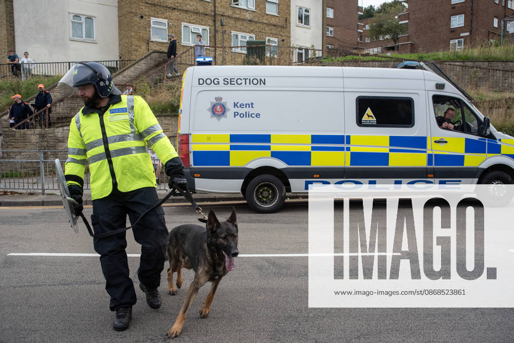 A member of the police dog unit with his German Shepherd during a demonstration in Dover. Supporters of the English Defence League (EDL) gathered in Dover, UK to march through the town all the way to the harbour. English Defence League is an extreme far-right and Islamophobic organisation. It was founded by Tommy Robinson (pseudonym of Steven Yaxley-Lennon) in 2009. Dover United Kingdom - ZUMAs197 20261003_aaa_s197_251