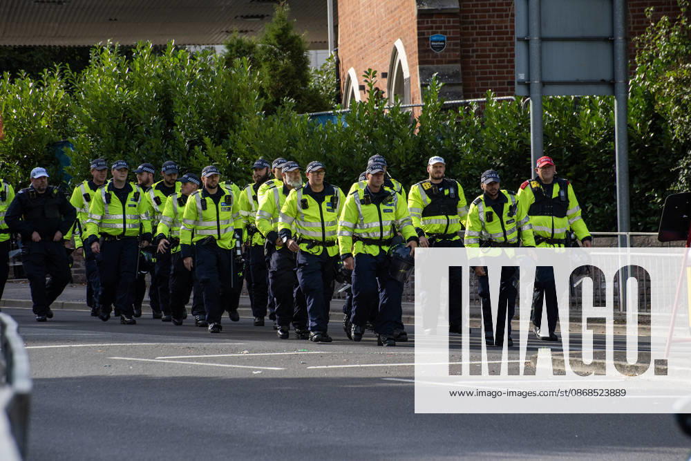 Police officers march to the protest starting point in Dover. Supporters of the English Defence League (EDL) gathered in Dover, UK to march through the town all the way to the harbour. English Defence League is an extreme far-right and Islamophobic organisation. It was founded by Tommy Robinson (pseudonym of Steven Yaxley-Lennon) in 2009. Dover United Kingdom - ZUMAs197 20261003_aaa_s197_255
