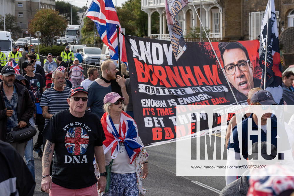 Far-right protesters march with banner and flags to the harbour during a demonstration in Dover. Supporters of the English Defence League (EDL) gathered in Dover, UK to march through the town all the way to the harbour. English Defence League is an extreme far-right and Islamophobic organisation. It was founded by Tommy Robinson (pseudonym of Steven Yaxley-Lennon) in 2009. Dover United Kingdom - ZUMAs197 20261003_aaa_s197_256