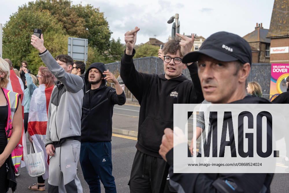 Far-right protesters show gestures to the antifascist counter-protesters during a demonstration in Dover. Supporters of the English Defence League (EDL) gathered in Dover, UK to march through the town all the way to the harbour. English Defence League is an extreme far-right and Islamophobic organisation. It was founded by Tommy Robinson (pseudonym of Steven Yaxley-Lennon) in 2009. Dover United Kingdom - ZUMAs197 20261003_aaa_s197_259