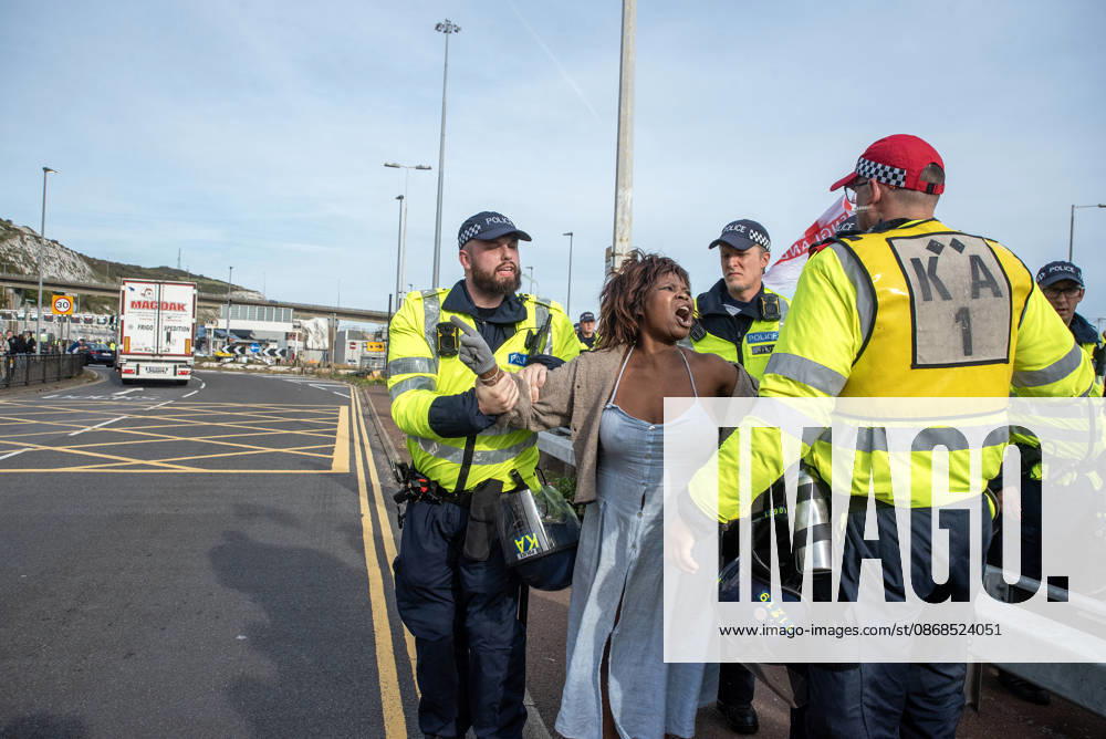 A bystander angrily shouts at the far-right protesters while the police officers hold her back during a demonstration near the harbour in Dover. Supporters of the English Defence League (EDL) gathered in Dover, UK to march through the town all the way to the harbour. English Defence League is an extreme far-right and Islamophobic organisation. It was founded by Tommy Robinson (pseudonym of Steven Yaxley-Lennon) in 2009. Dover United Kingdom - ZUMAs197 20261003_aaa_s197_261