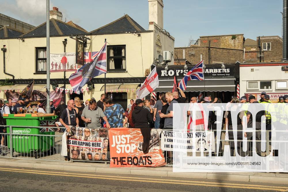 Dover, United Kingdom of Great Britain and Northern Ireland: DOVER, UNITED KINGDOM, OCTOBER 3, 2026: Anti-immigration protesters and anti-racism counter-protesters gather during rival demonstrations in Dover, Kent. Anti-immigration demonstrators carrying Union flags and St George s flags displayed banners calling for deportations and an end to small-boat crossings, while counter-protesters gathered nearby. Police maintained a significant presence between the groups and monitored the demonstrations. Dover United Kingdom of Great Britain and Northern Ireland - ZUMAq101 20261003_zna_q101_206