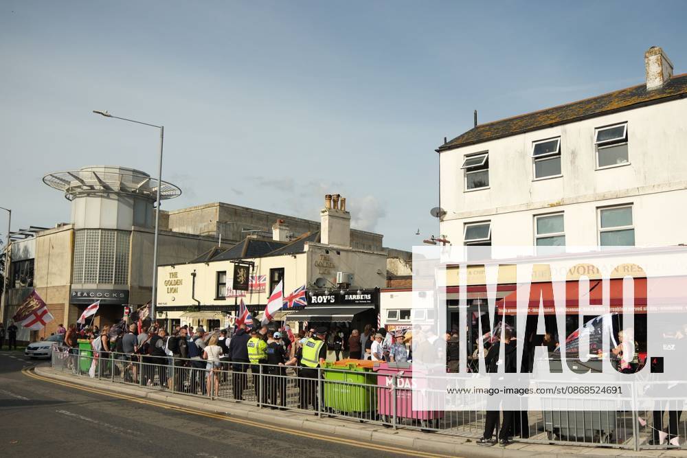 Dover, United Kingdom of Great Britain and Northern Ireland: DOVER, UNITED KINGDOM, OCTOBER 3, 2026: Anti-immigration protesters and anti-racism counter-protesters gather during rival demonstrations in Dover, Kent. Anti-immigration demonstrators carrying Union flags and St George s flags displayed banners calling for deportations and an end to small-boat crossings, while counter-protesters gathered nearby. Police maintained a significant presence between the groups and monitored the demonstrations. Dover United Kingdom of Great Britain and Northern Ireland - ZUMAq101 20261003_zna_q101_211