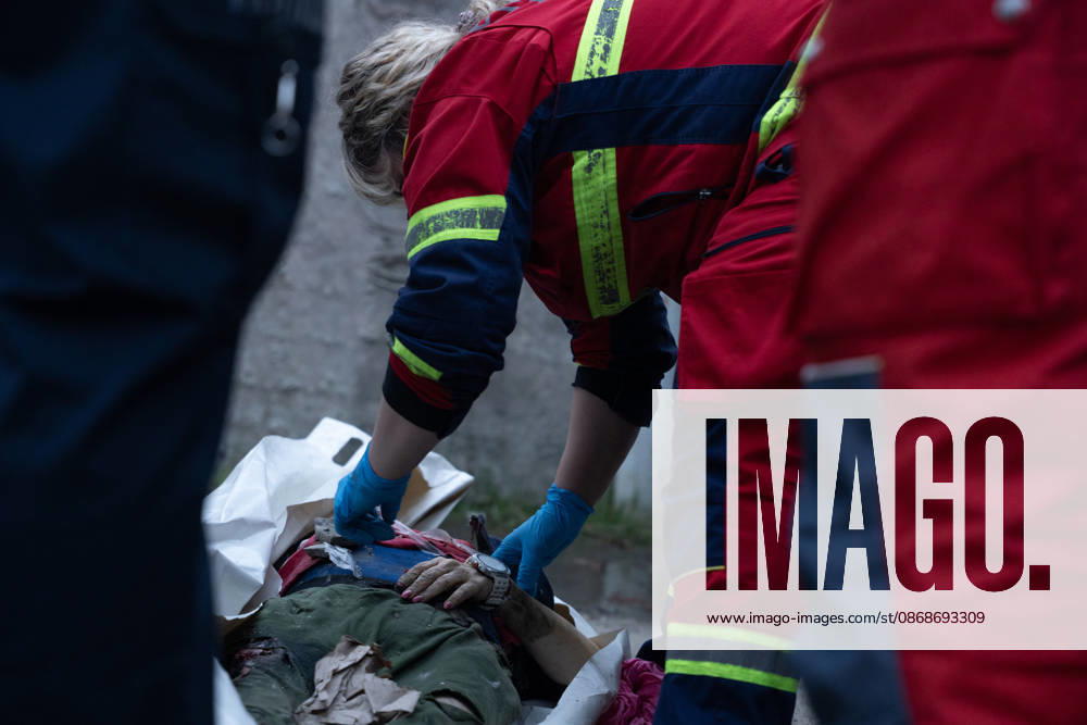 Local rescue workers identify the body of a woman following a Russian aerial attack on a bus repair warehouse in Kharkiv, Ukraine. Two people were killed in the attack, while emergency crews, firefighters and Red Cross volunteers worked to clear the rubble and search the damaged site. Kharkiv Ukraine - ZUMAm350 20261005_zip_m350_019